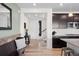 Home entryway featuring wood floors, a coat rack and views of the kitchen and staircase at 3014 Furthermore Ln, Castle Rock, CO 80108