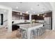 Modern kitchen featuring dark wood cabinets, stainless steel appliances, and large island at 3014 Furthermore Ln, Castle Rock, CO 80108