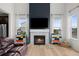 Stylish living room with a cozy fireplace, accent wall, and hardwood floors at 3014 Furthermore Ln, Castle Rock, CO 80108