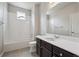 Bright bathroom showcasing a single sink vanity, a tub-shower combo and a window for natural light at 9269 Garnett St # C, Arvada, CO 80007