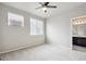 Well-lit bedroom with plush carpet, ceiling fan and an ensuite bathroom with a dark vanity at 9269 Garnett St # C, Arvada, CO 80007
