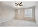 Bright and airy bedroom with neutral carpeting and natural light from large windows at 9269 Garnett St # C, Arvada, CO 80007