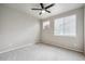 Neutral bedroom with a ceiling fan, two windows with blinds, and plush carpeting at 9269 Garnett St # C, Arvada, CO 80007