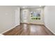 Bright entryway featuring hardwood floors, a window, and a front door with glass panels at 9269 Garnett St # C, Arvada, CO 80007