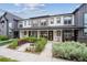 Charming townhome featuring a covered front porch and well-maintained landscaping at 9269 Garnett St # C, Arvada, CO 80007