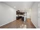 Contemporary kitchen featuring dark cabinets, a central island, and hardwood flooring at 9269 Garnett St # C, Arvada, CO 80007