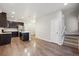 Open-concept kitchen with a center island, dark cabinetry, and stainless steel appliances at 9269 Garnett St # C, Arvada, CO 80007