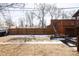 Expansive backyard featuring a wooden fence, deck, and a mix of grassy and bare areas at 2664 S Grant St, Denver, CO 80210