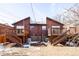 Spacious backyard featuring a wooden deck, a well-maintained lawn, and cozy seating for outdoor relaxation and entertainment at 2664 S Grant St, Denver, CO 80210