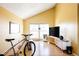 Bright living room with large windows, hardwood floors, vaulted ceiling, and modern furniture at 2664 S Grant St, Denver, CO 80210