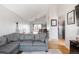 Open-concept living room with views to the adjacent dining area, hardwood floors, and modern furniture. The perfect space for gatherings at 2664 S Grant St, Denver, CO 80210