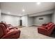 Finished basement with two red couches at 1434 Hickory Dr, Erie, CO 80516