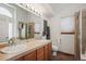 Bathroom with double sinks, shower, and toilet at 1434 Hickory Dr, Erie, CO 80516