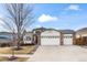 Brick ranch home with three-car garage and landscaped yard at 1434 Hickory Dr, Erie, CO 80516