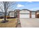 Two-story house with a three-car garage and well-maintained landscaping at 1434 Hickory Dr, Erie, CO 80516