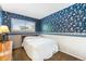 Cozy bedroom featuring a comfortable bed and natural light from the window at 628 S Carr St, Lakewood, CO 80226