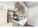 Well-lit kitchen boasts stainless steel appliances, ample counter space, and stylish shutters at 628 S Carr St, Lakewood, CO 80226