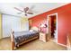 Comfortable primary bedroom with ample closet space, ensuite bathroom, and a ceiling fan at 628 S Carr St, Lakewood, CO 80226
