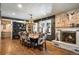 Inviting dining room featuring a stone fireplace, wood floors, a modern chandelier, and cow print chairs at 1205 Lee St, Lakewood, CO 80215