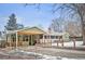 Charming single-story home with a brick chimney, spacious carport and fenced front yard at 1205 Lee St, Lakewood, CO 80215