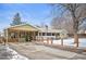 Charming single-story home with a brick chimney, spacious carport, and an enclosed front yard at 1205 Lee St, Lakewood, CO 80215