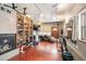 Home gym featuring workout equipment, a wood-burning fireplace, and built in storage cabinets at 1205 Lee St, Lakewood, CO 80215