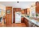 Traditional kitchen with wooden cabinets, stainless steel appliances, granite countertops, and natural light at 1205 Lee St, Lakewood, CO 80215