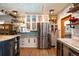 Modern kitchen with stainless steel appliances, a center island, and wood floors for a clean design at 1205 Lee St, Lakewood, CO 80215