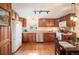 Charming kitchen featuring wood cabinets, stainless steel appliances, and a bright window at 1205 Lee St, Lakewood, CO 80215