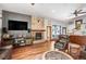 Spacious living room with a beautiful stone fireplace, hardwood floors, and comfortable leather furniture at 1205 Lee St, Lakewood, CO 80215