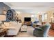 Spacious living room with blue accent wall, large sofa, and ample seating at 1205 Lee St, Lakewood, CO 80215