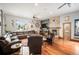 Spacious living room with hardwood floors, a stone fireplace, and large window with hanging plants at 1205 Lee St, Lakewood, CO 80215