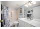 Bright bathroom featuring a tub/shower, white vanity with marble counter, and decorative touches at 13952 E Marina Dr # 310, Aurora, CO 80014
