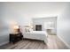 Cozy bedroom featuring a queen-sized bed, dark wood furniture, and a bright window at 13952 E Marina Dr # 310, Aurora, CO 80014