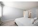 Bright bedroom with white bed, window, and light wood flooring at 13952 E Marina Dr # 310, Aurora, CO 80014