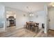 Open concept dining room with wood table, chairs, wood floors, and view into updated kitchen at 13952 E Marina Dr # 310, Aurora, CO 80014