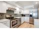 Modern kitchen featuring stainless steel appliances, white cabinets, and tile backsplash at 13952 E Marina Dr # 310, Aurora, CO 80014