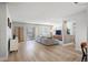 Open living room with wood floors, balcony, comfortable couch and bright light at 13952 E Marina Dr # 310, Aurora, CO 80014