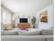 Bright living room featuring a comfortable couch, entertainment center, and stylish decor at 13952 E Marina Dr # 310, Aurora, CO 80014