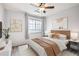 Bright bedroom featuring ceiling fan, lighting, art and windows at 2662 S Cathay Way # 302, Aurora, CO 80013