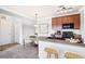 Kitchen with wood cabinets, black appliances, tile flooring, and bar seating, seamlessly flowing to dining at 2662 S Cathay Way # 302, Aurora, CO 80013