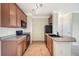 Functional kitchen with wood cabinets, black appliances, tile flooring, and convenient access to multiple doorways at 2662 S Cathay Way # 302, Aurora, CO 80013