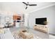 Cozy living room featuring carpet, a ceiling fan, contemporary furnishings, and seamlessly connected dining and kitchen areas at 2662 S Cathay Way # 302, Aurora, CO 80013