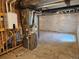 Unfinished basement with water heater, exposed ducts, and insulated walls at 6077 Idlewild Pl, Brighton, CO 80601