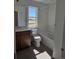 Bright bathroom features a vanity, toilet, bathtub, and window offering natural light at 6077 Idlewild Pl, Brighton, CO 80601