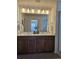 Bathroom featuring a double vanity and a large mirror at 6077 Idlewild Pl, Brighton, CO 80601