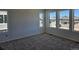 New carpeted bedroom with bright natural light from four windows overlooking neighborhood at 6077 Idlewild Pl, Brighton, CO 80601