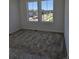 New carpeted bedroom with bright natural light from two large windows at 6077 Idlewild Pl, Brighton, CO 80601