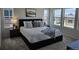 Inviting bedroom filled with natural light and featuring stylish bedside decor, a comfy bed, and exterior views at 6077 Idlewild Pl, Brighton, CO 80601