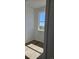 Bright bedroom with wood floors, a large window offering natural light and outdoor views at 6077 Idlewild Pl, Brighton, CO 80601